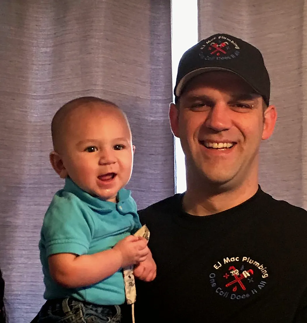 Dustin MacDonald in an EJ Mac Plumbing cap and shirt