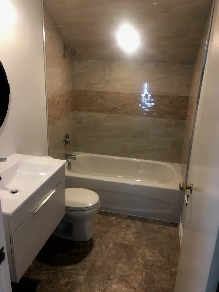 Bathroom with a new tub, vanity and toilet