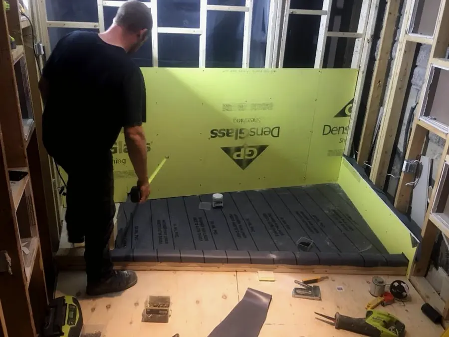 Setting a shower base during a bathroom rough-in